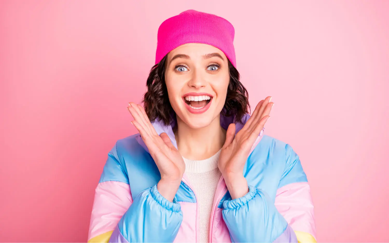 Happy Woman Smiling In A Pink Beanie And Pastel Jacket